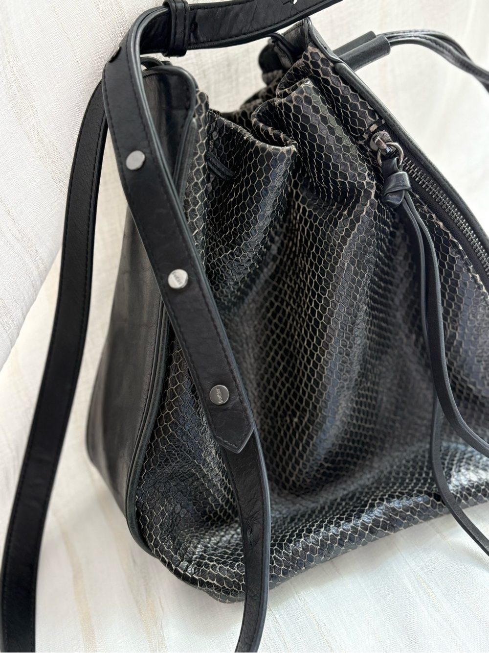 Botkier Snake-Embossed
Leather Tassel Drawstring Crossbody Bucket Bag.
